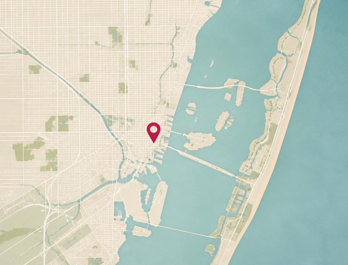 Illustrated map of Miami and Biscayne Bay with a crimson pin over downtown
